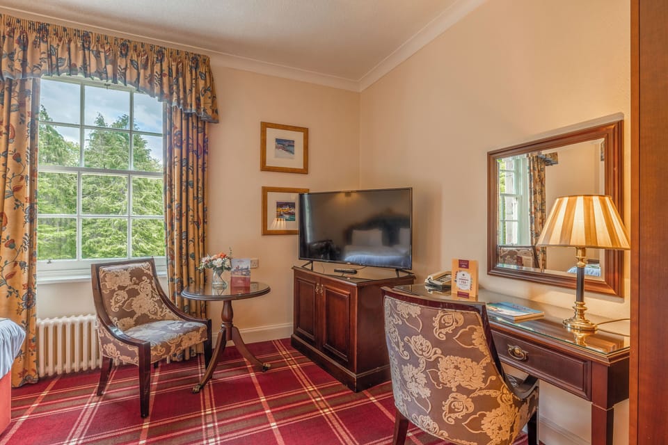 Sip morning coffee by the window with leafy views.
