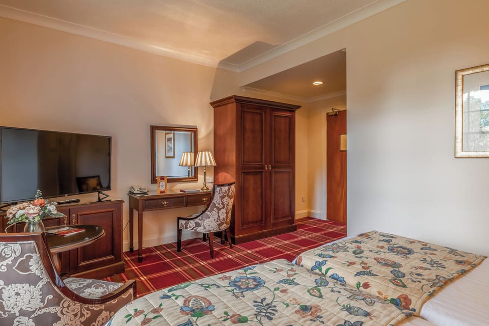 Settle in with wardrobe space and a classic writing desk.
