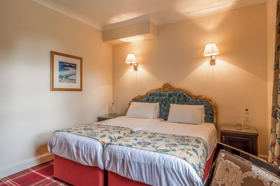 Unwind into crisp linens beneath warm, softly glowing lights.