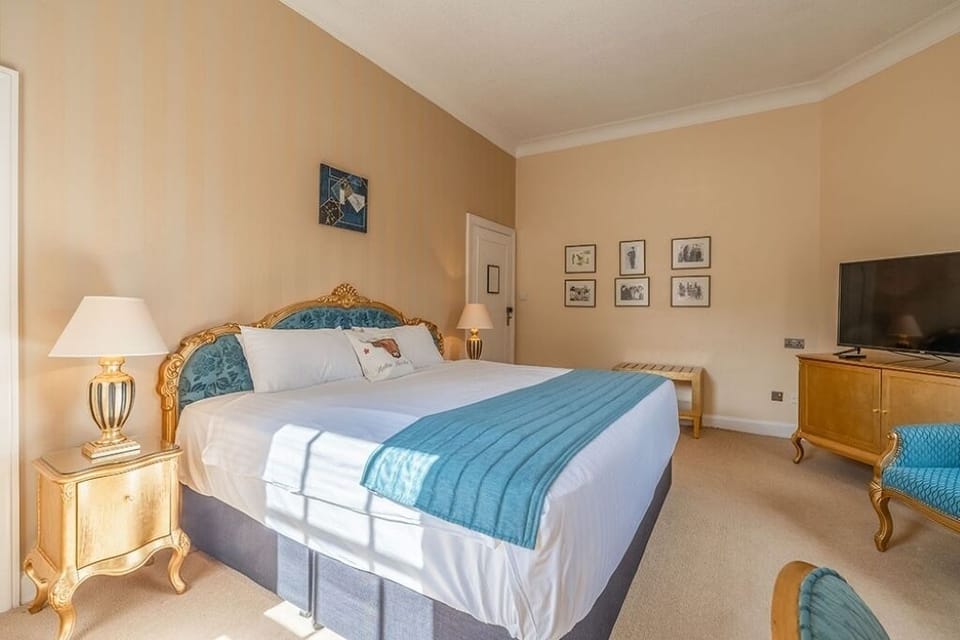 Sink into crisp linens beneath a beautifully dressed headboard.