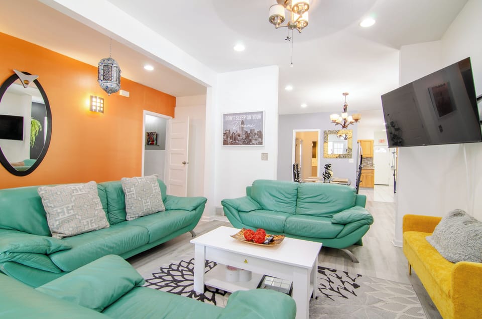Bright space featuring a stylish green sofa