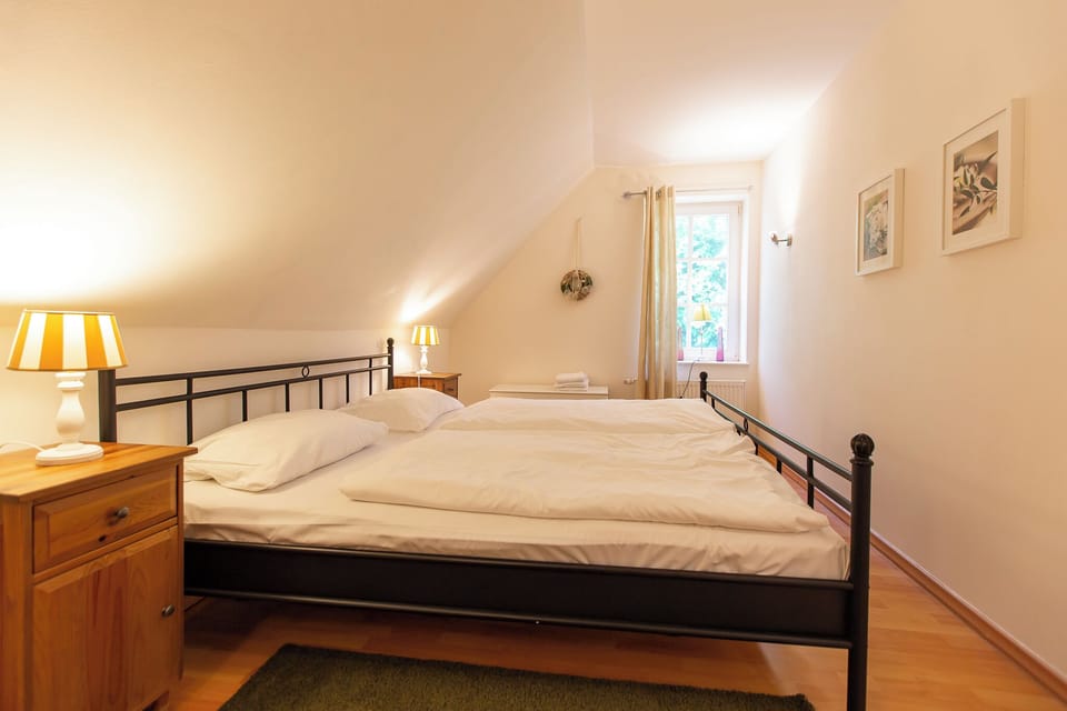 Bedroom with Two Single Beds and Wooden Dresser