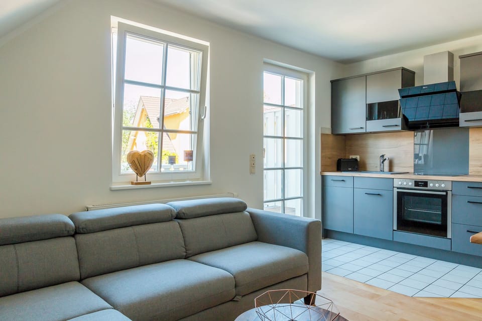 Living Room with Gray Sofa and Modern Kitchen