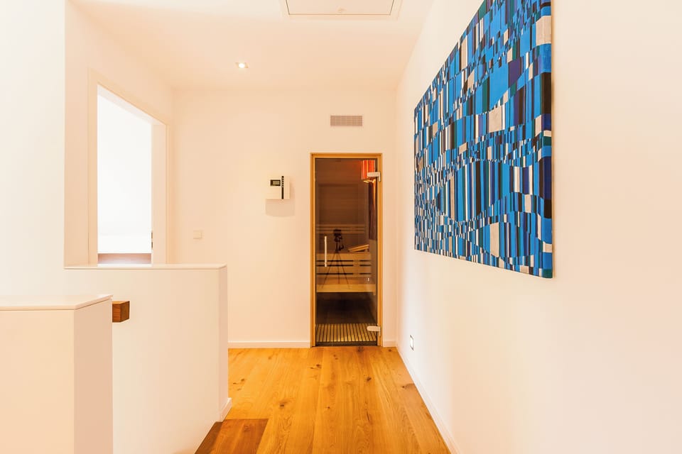 Bright Hallway with Wooden Floor and Wall Artwork