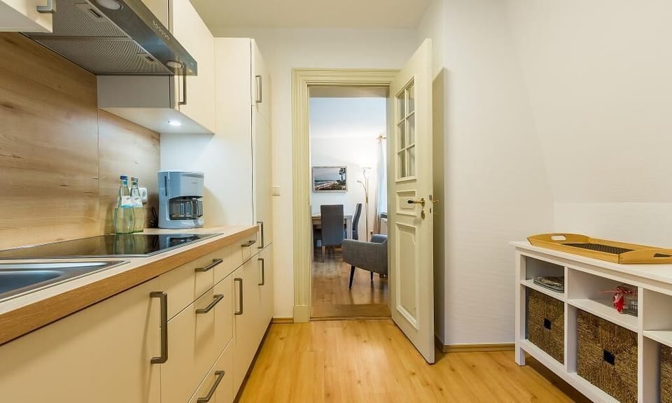 Modern kitchen with wooden shelves and dining area
