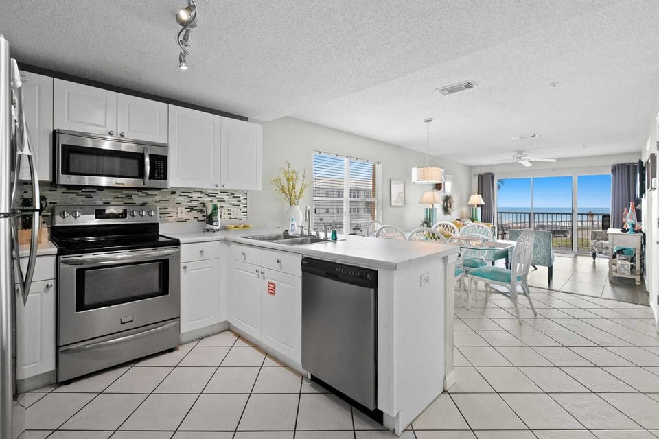 A clean, well-appointed kitchen with stainless appliances and everything you need to cook in.