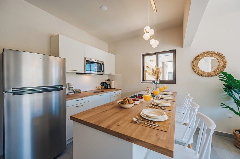 Sleek kitchen with full-size appliances and warm lighting—ideal for cooking up island-inspired meals.

