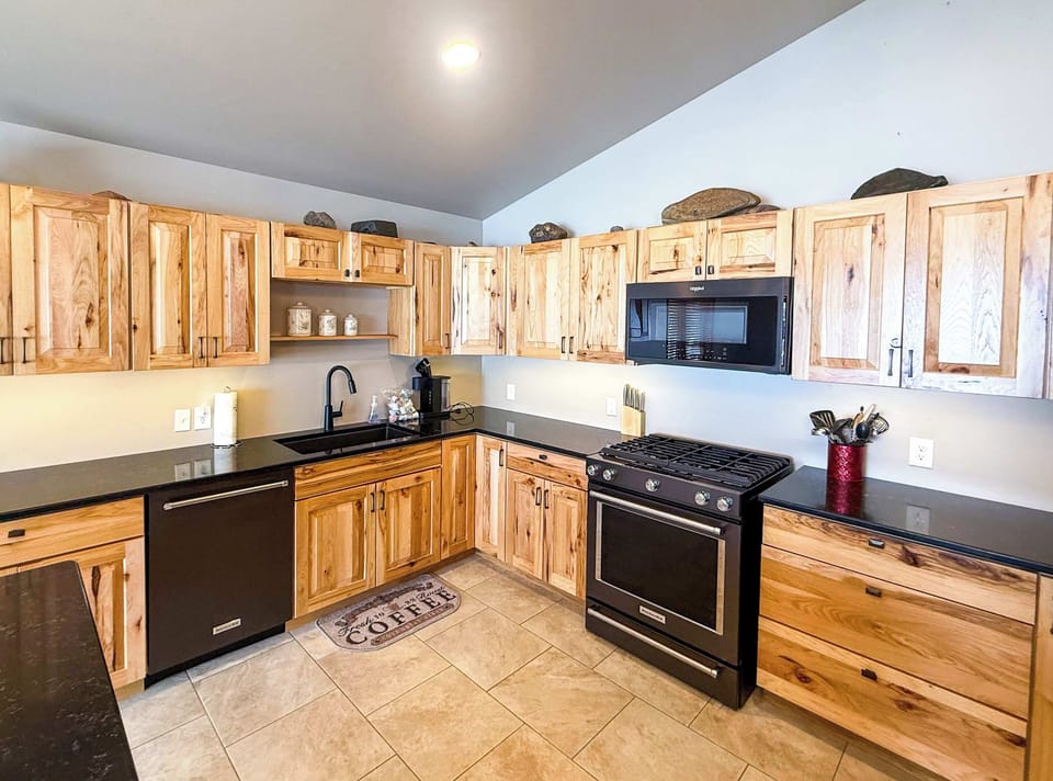 Full kitchen with gas range, dishwasher, microwave and refrigerator