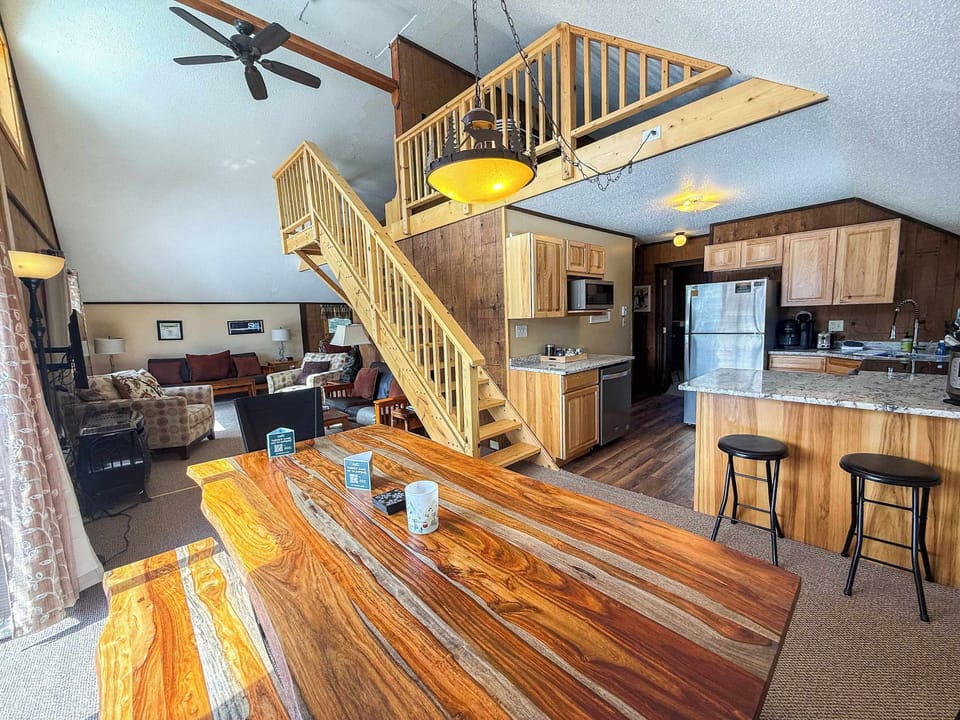 View from the dining room of the kitchen, loft, dining room and living room space