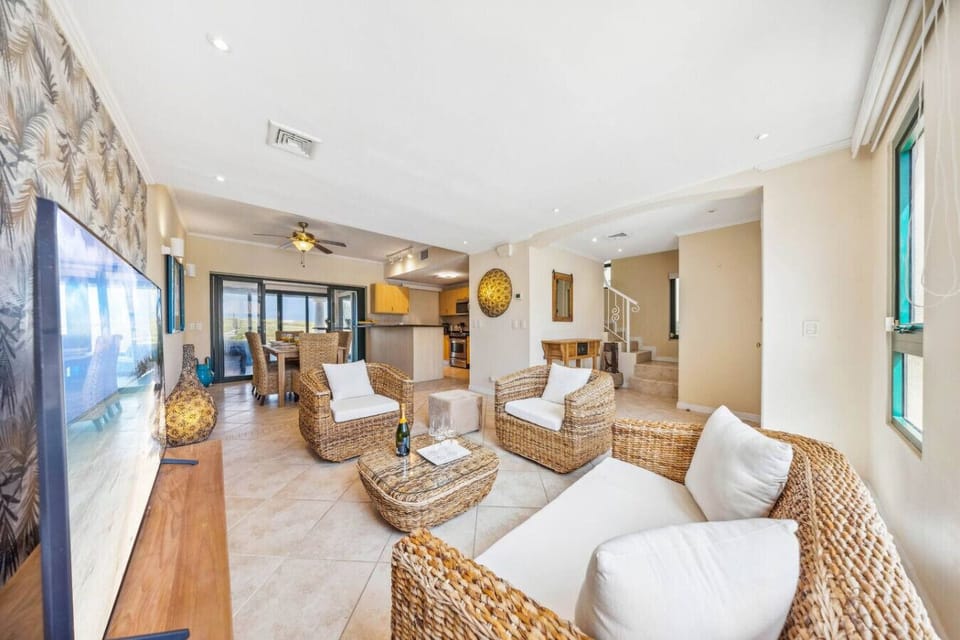 Kick back and enjoy your favorite movies in the spacious living area featuring a cozy rattan sofa