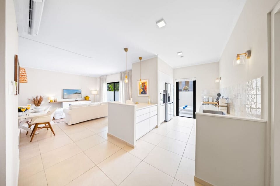 Flow effortlessly between chic kitchen and cozy living space built perfectly for hosting.
