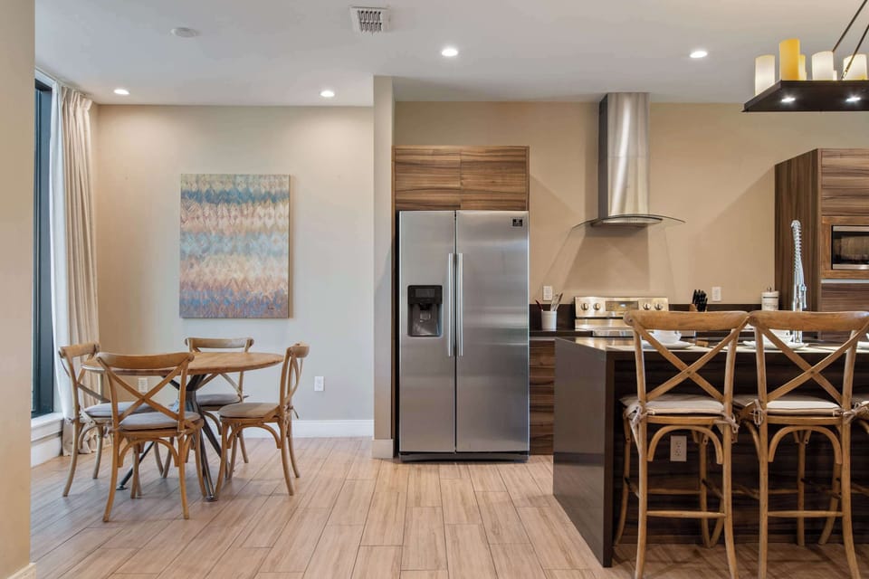 Modern kitchen with stainless appliances, breakfast nook, and spacious island seating.