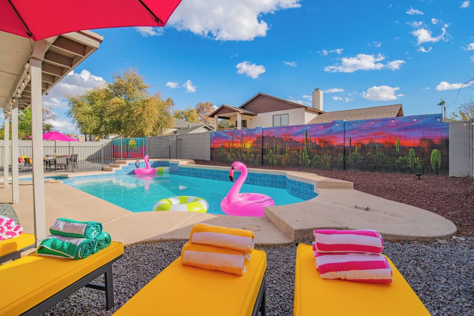 Stunning backyard with a heated pool & spa, vibrant loungers for perfect evening