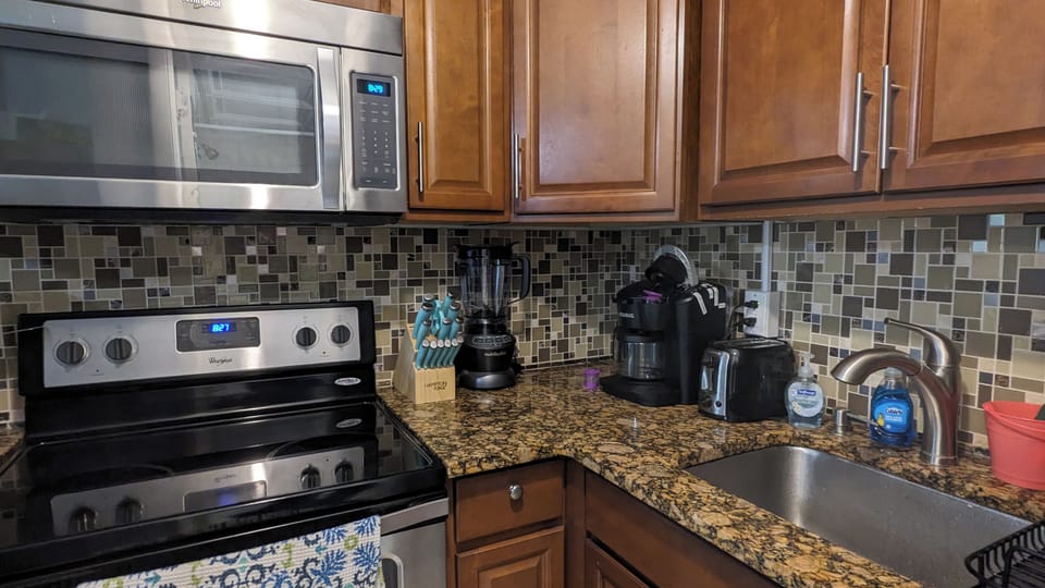 Kitchen with full sized stove and microwave, along with appliances