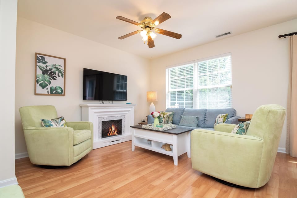 First fl living room includes a smart tv, fireplace, and comfortable seating.