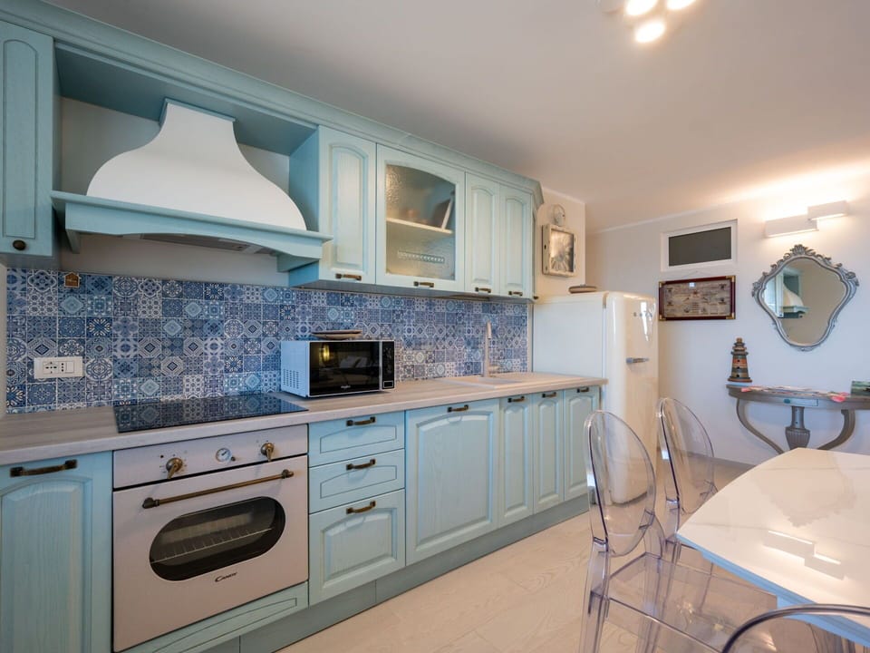 Blue, Kitchen, Interior Design, Countertop, Flooring, Cabinetry, Floor, Furniture, Major Appliance, Lighting