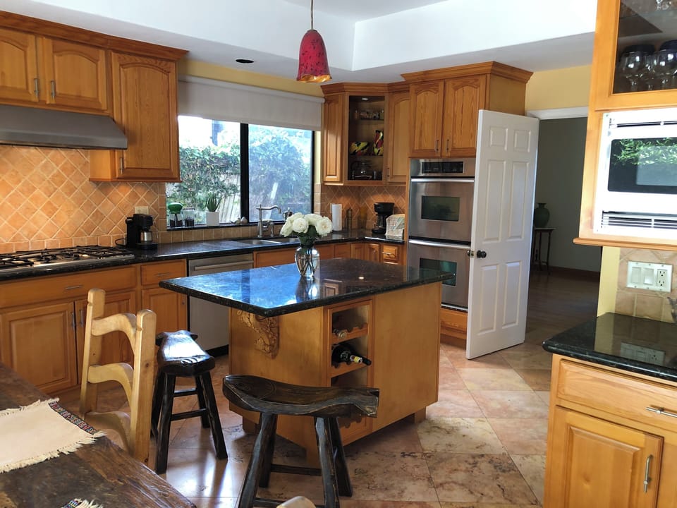 Kitchen with stainless steel appliances, granite counter tops, gas stove.