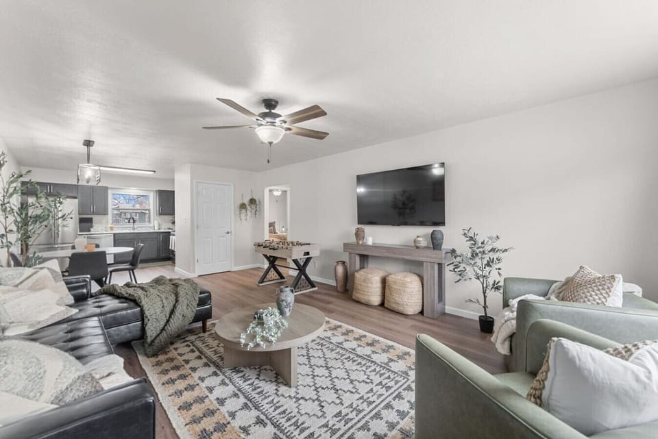 Main Living Room View (with kitchen) 🛋️ Open-concept living with cozy seating, large TV, and foosball fun!