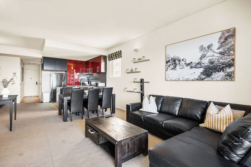Cozy living room with plush leather sofa, stylish decor, and entertainment.