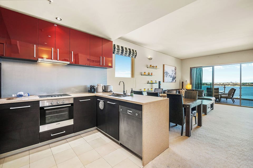 Spacious living area with plush sofa and modern vibrant cabinetry.