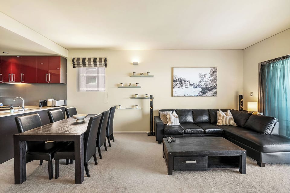 A stylish open-plan space combining living, dining, and kitchen areas for easy relaxation and socializing.