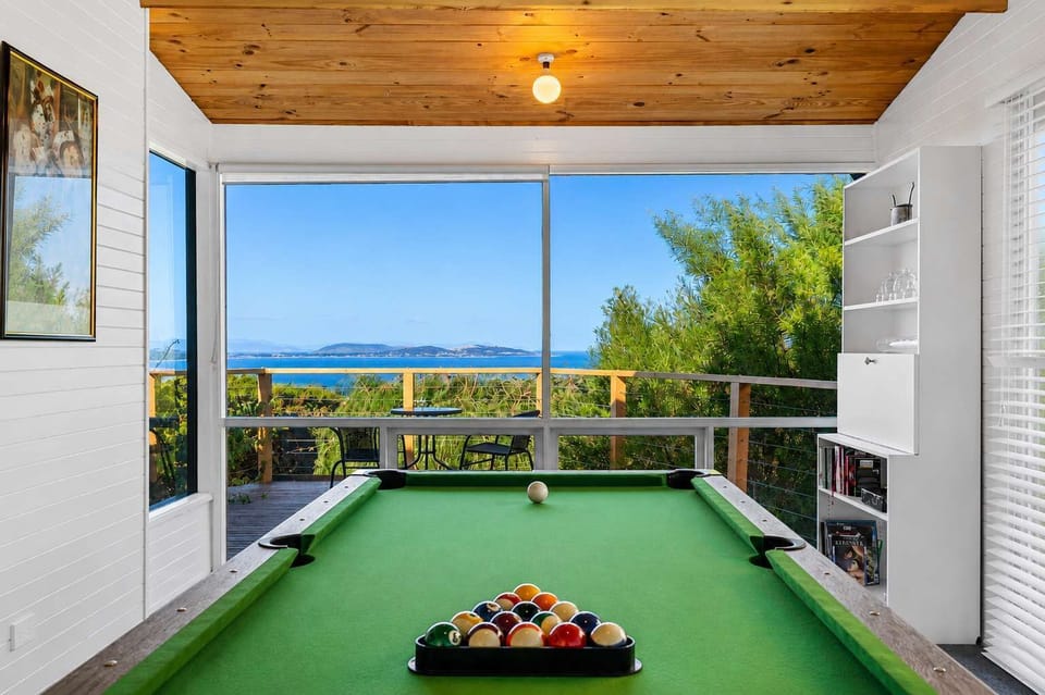 Challenge family and friends to a game of pool while enjoying the water views.
