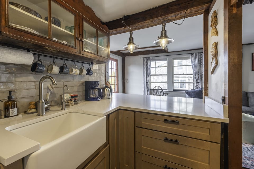 Kitchen stocked with cooking items and dishes/flatware