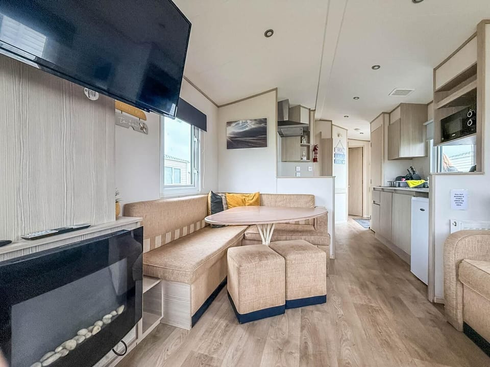 Cozy living and dining area with modern fireplace and TV