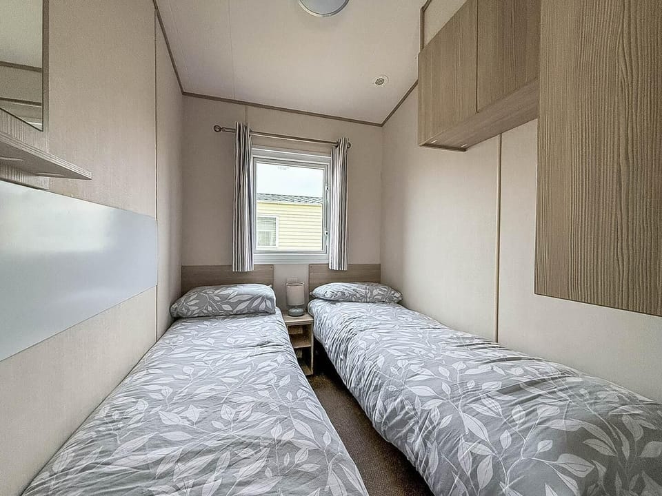 Cozy twin bedroom with natural light and smart storage