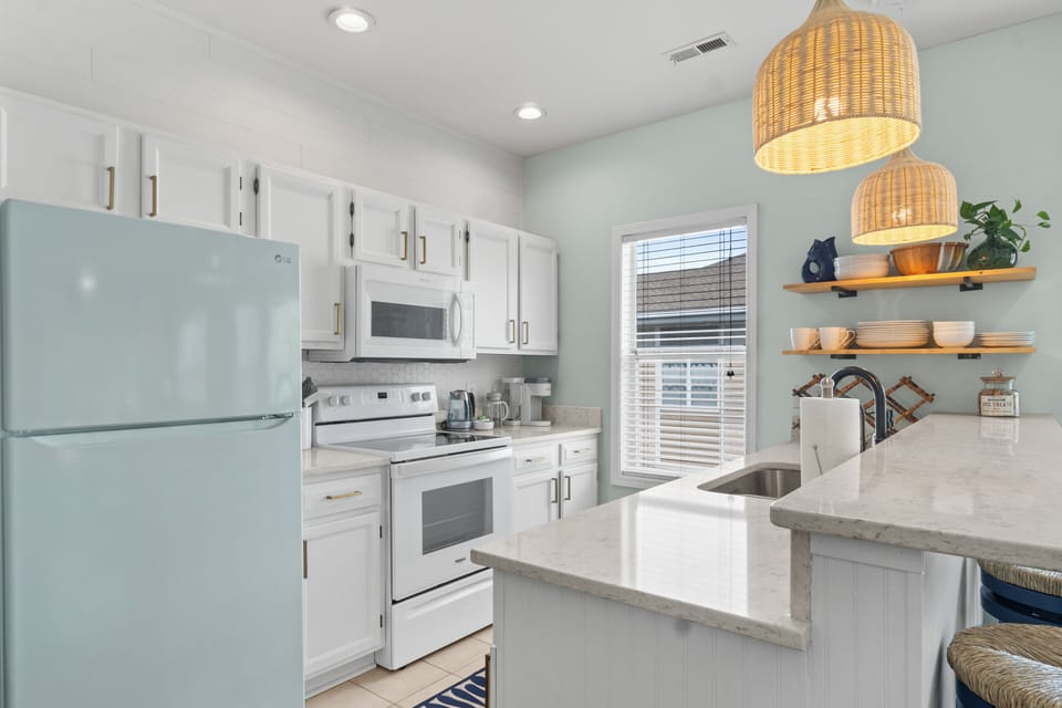 Fully stocked kitchen with coastal vibes and quartz countertops
