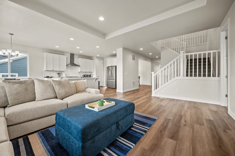A modern sectional sofa and wood flooring create a stylish, cozy space perfect for relaxing after a day of adventure.