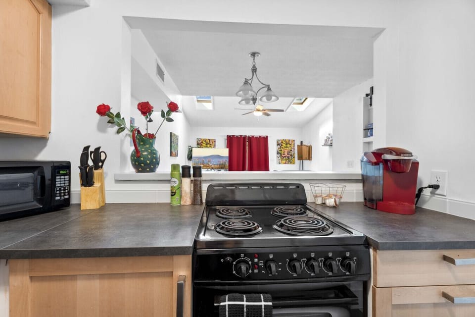 Kitchen: Whip up culinary delights in this bright, art-filled kitchen with stylish decor!