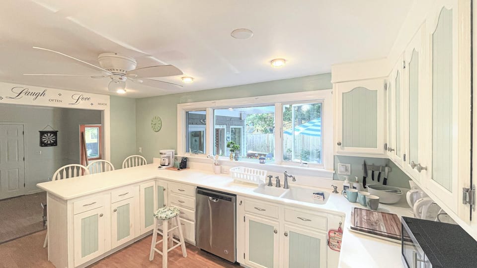 Kitchen with Breakfast Island Opening to Family Room (2 steps inbetween)