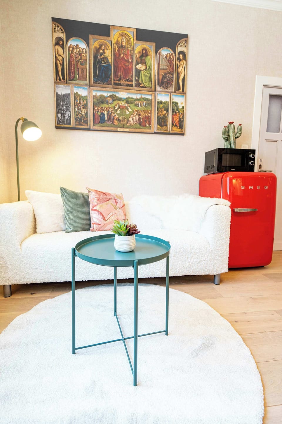 Art-filled living room with vibrant red accents.