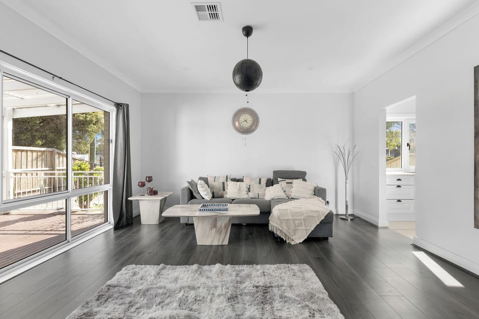 Living room with Sofa, table and massive window for natural light.