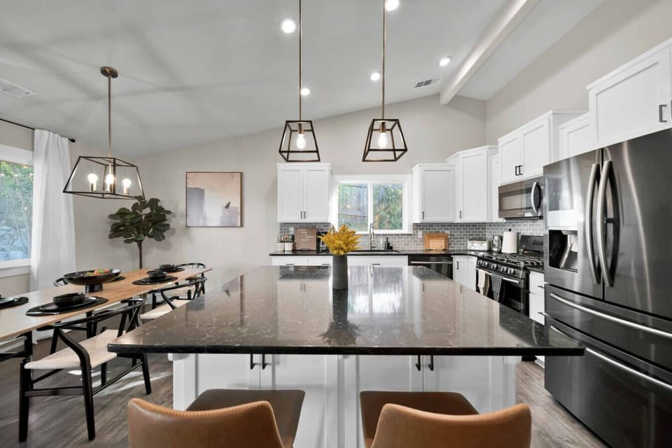 This fully-equipped kitchen features modern appliances and ample prep space.
