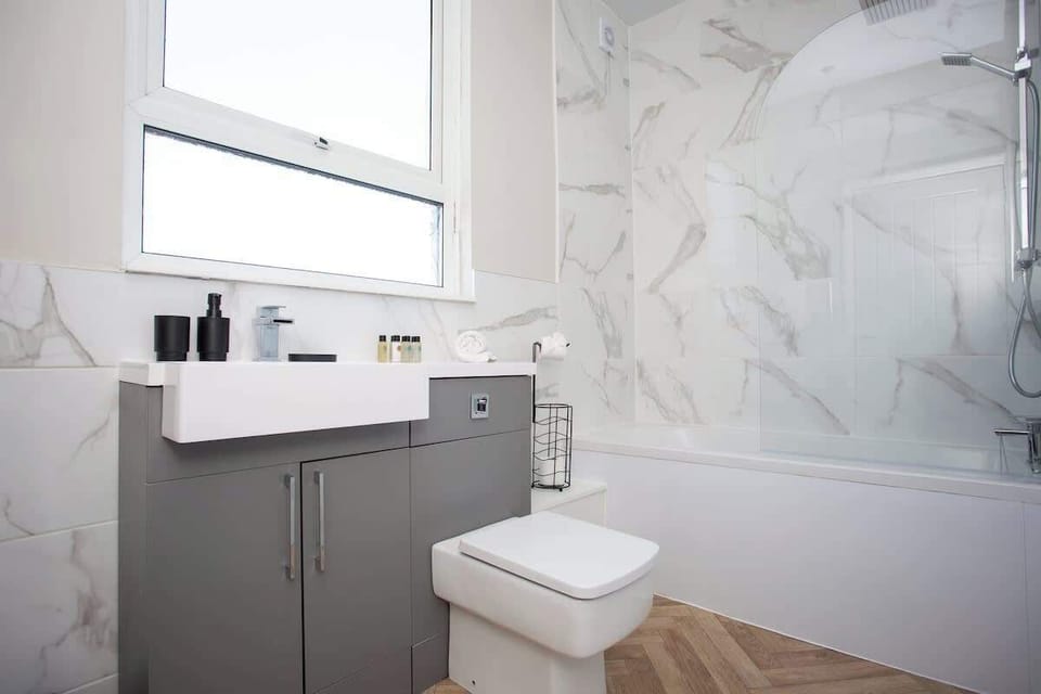 Tiled bathroom with a clean, minimalist design and all essentials ready for your stay.