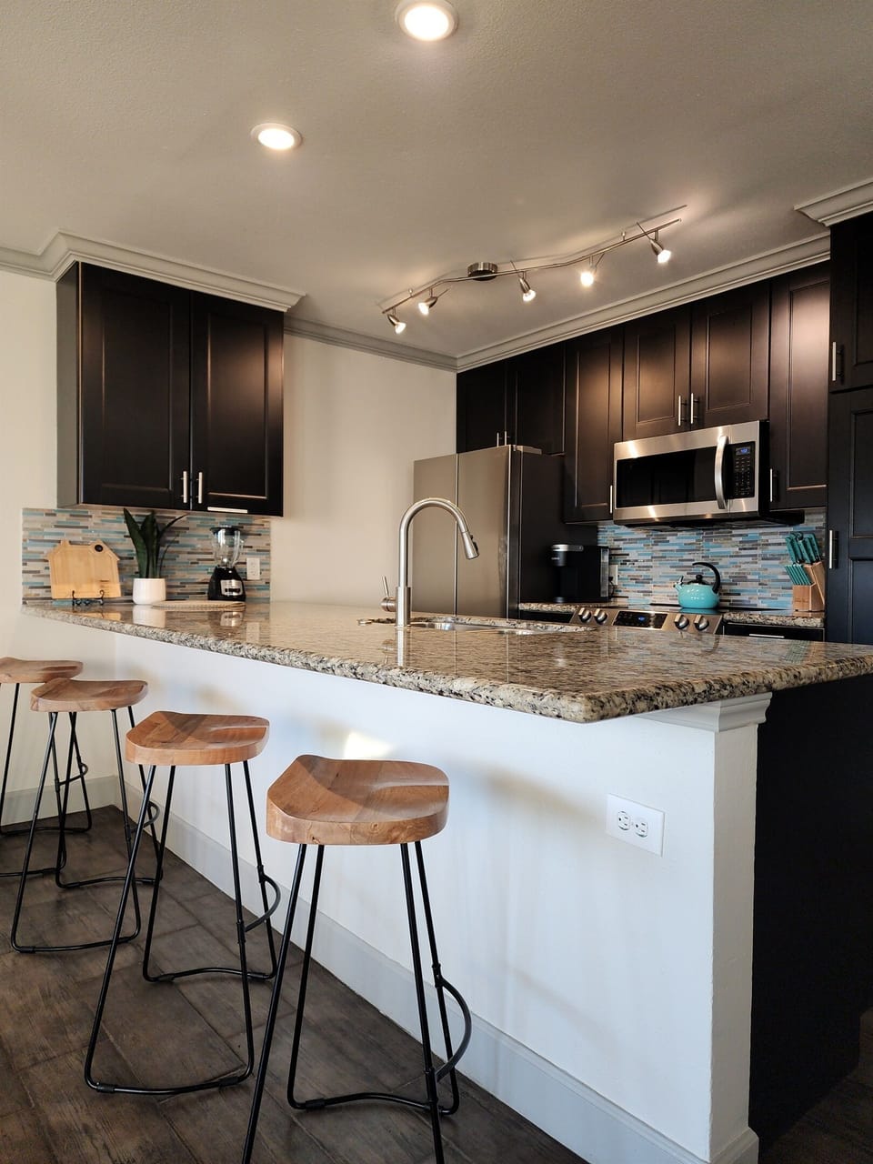 Lots of storage with granite and tile backsplash.