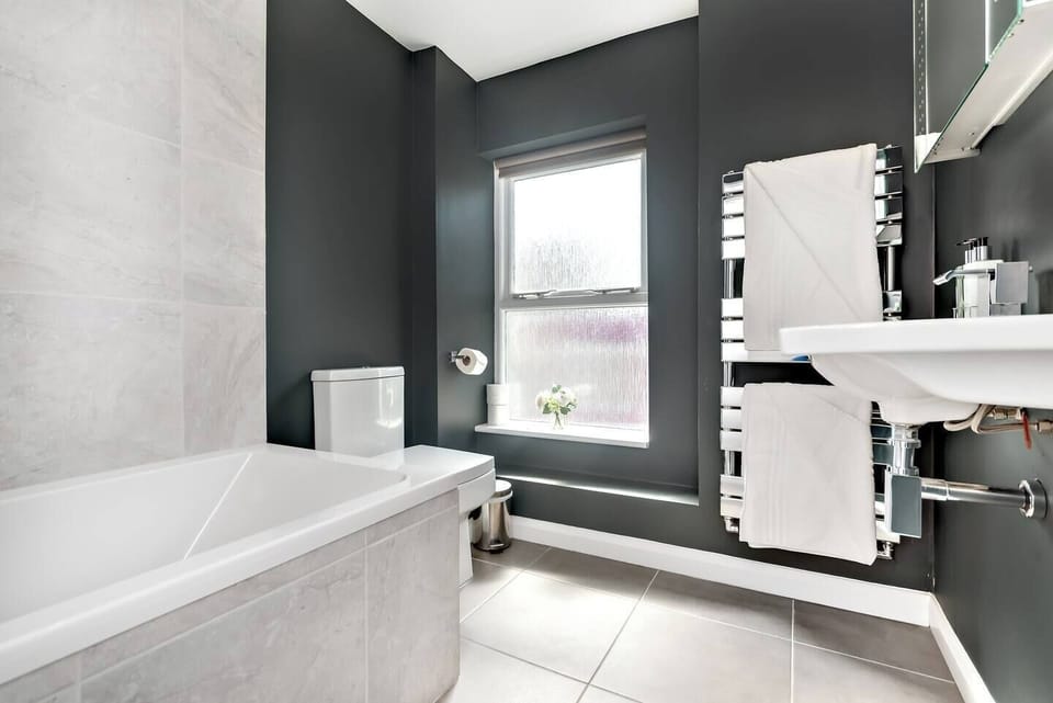 Large comfortable family bathroom with bath and shower.