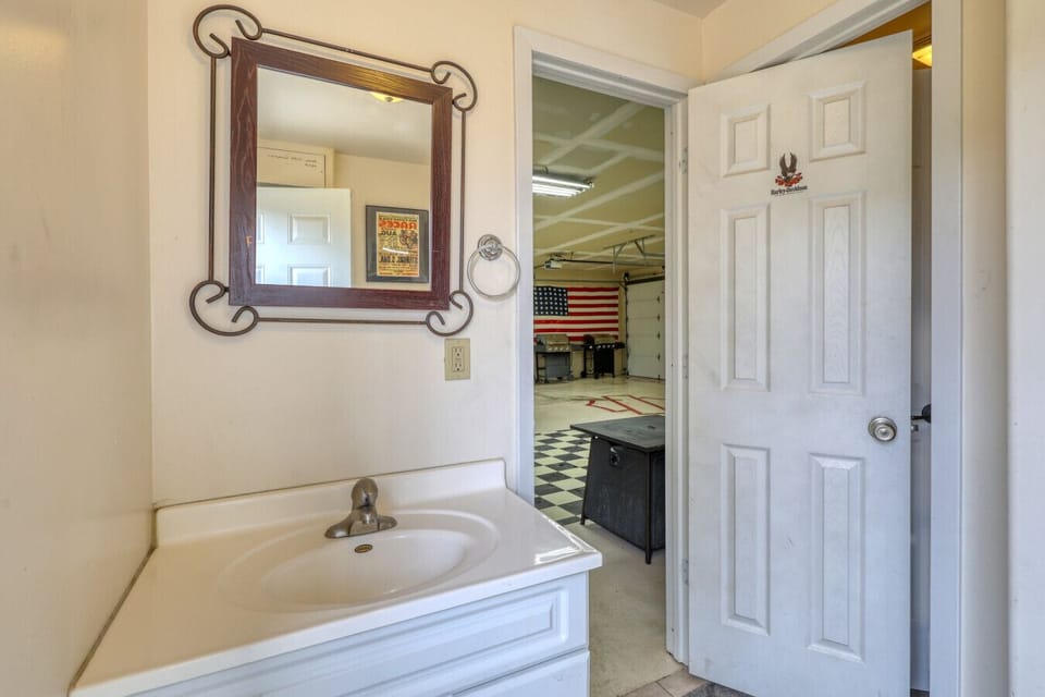 Garage bathroom with sink, toilet, and shower