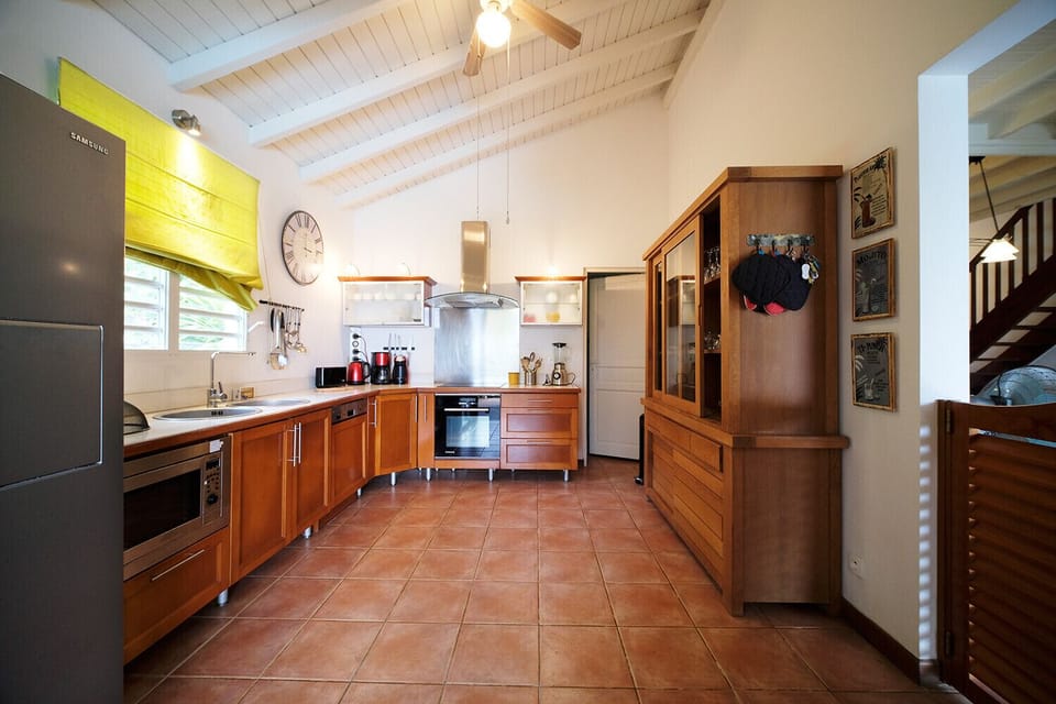 The kitchen at Villa Bwa Cacao is well equipped and benefits from the brightness of the openings not the swing doors, it is a pleasant place to cook.