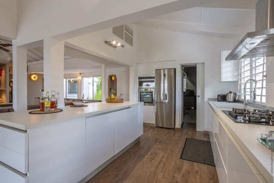 Functional kitchen open to the living room and terrace with access to the pool.