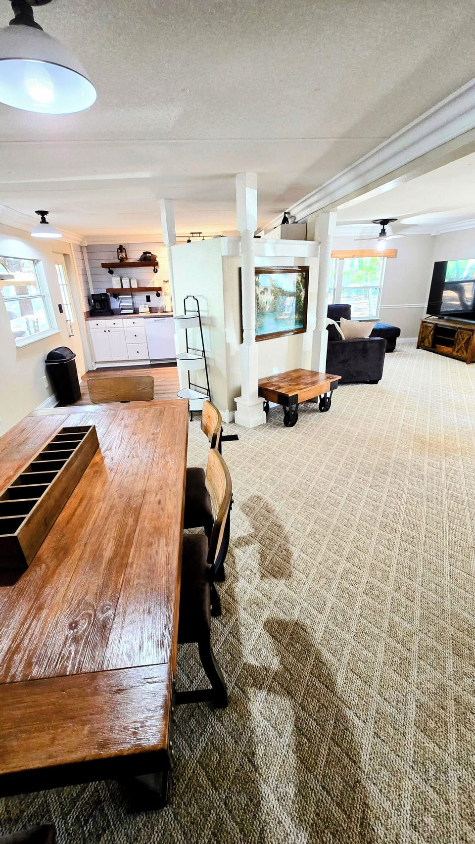 View from hallway, dining table left, kitchen  on left, living room on right.