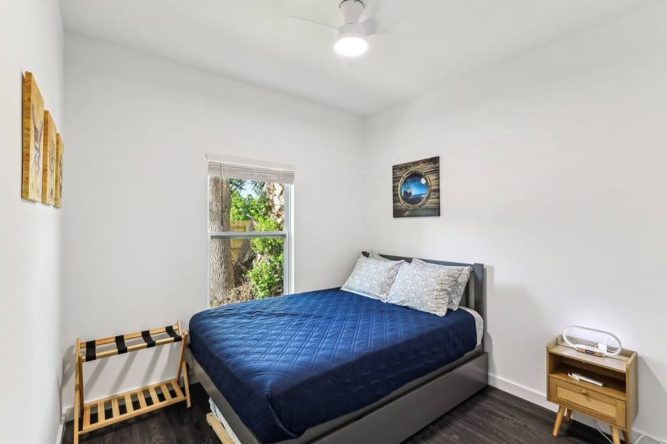 Queen bed with twin trundle underneath bed.  Closet with shelving and hangers.  Touch lamp with wireless cell phone charging.