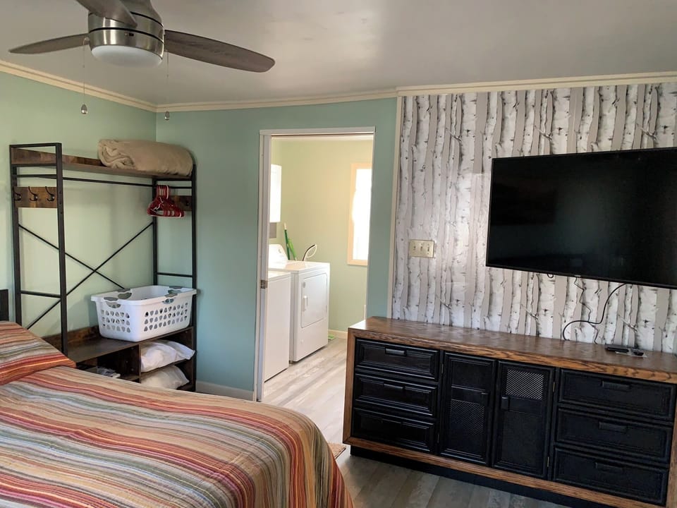 BEDROOM:  Cute bedroom with queen-size bed, ceiling fan, private streaming television, dresser, closet, nightstand, and lamp.