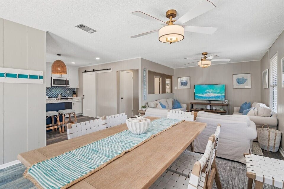 This open-plan space is ready for dinner parties at the big wooden table and movie nights on the comfy white couches.