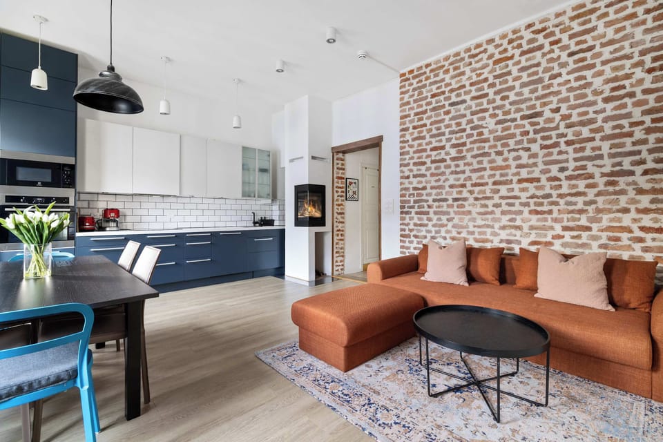 Brick accent wall adds a touch of rustic charm.