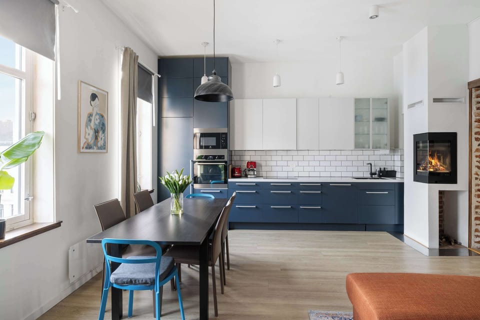 Dining area features a long table and stylish chairs.