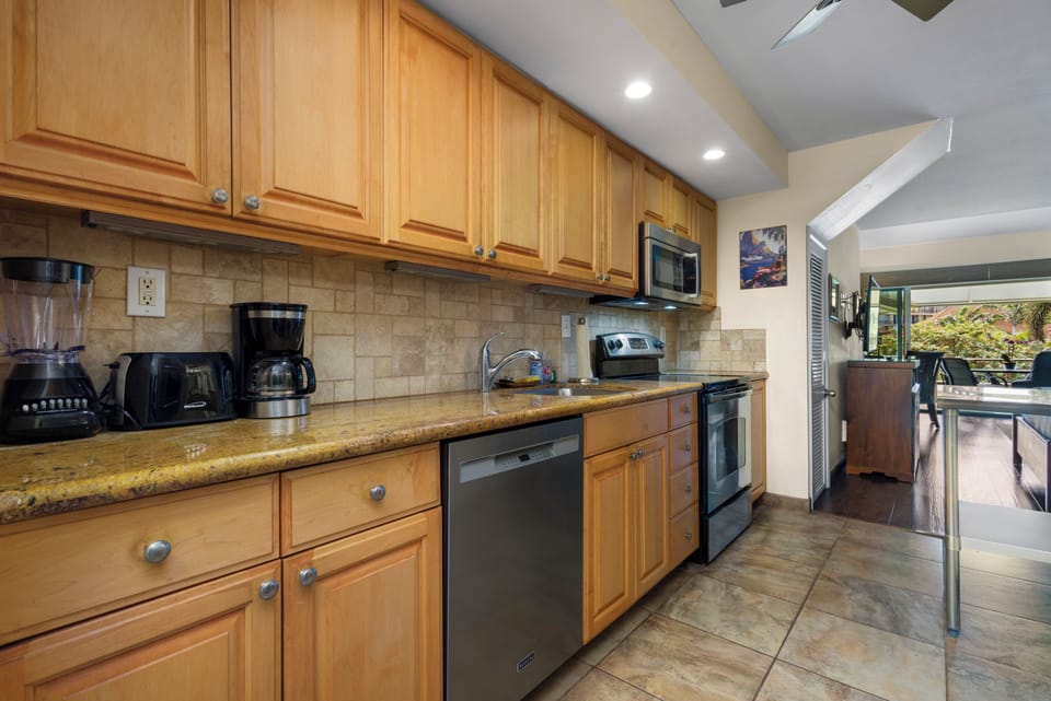 Your fully equipped kitchen features granite countertops, modern appliances, and all the essentials for preparing your favorite meals in a warm, inviting space with abundant natural light.