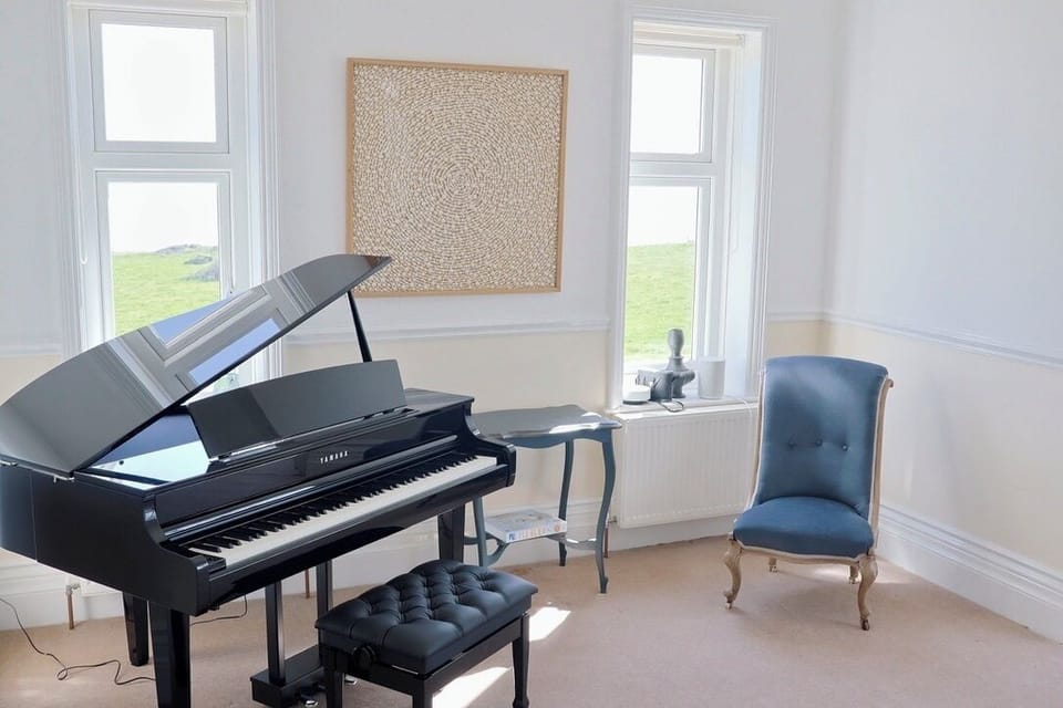 Additional living area with Yamaha electric baby grand piano (CLP-865GP)